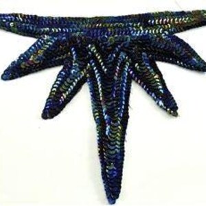 May include: A handcrafted, sequined starfish in shades of blue, green, and gold. The starfish has five long, pointed arms and is set against a white background. The sequins create a textured, shimmering effect.