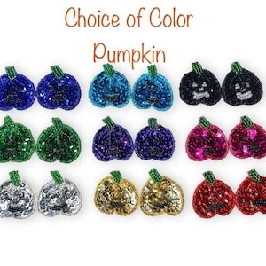 May include: A range of beaded pumpkin decorations in colours such as blue, green, purple, black, pink, gold, silver, and red. Each pumpkin has a green stem and a smiling face. The text "Choice of Color Pumpkin" is at the top.