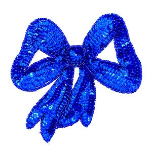 May include: A blue sequined bow with a center piece. The bow is made of small, round sequins that are sewn together to create a shimmering effect.