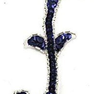 May include: A navy blue sequined letter "f" with a silver beaded outline. The cursive letter has a decorative flourish at the top and bottom. The background is plain white.