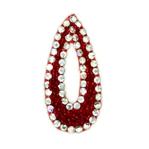 May include: A teardrop-shaped embellishment with a red beaded base, outlined with sparkling clear rhinestones. The center of the teardrop is open. This decorative element is suitable for various craft projects.