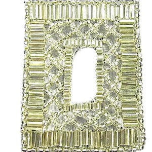 May include: A rectangular, beaded patch with a central cutout. The patch features a grid-like pattern of clear beads, with a border of vertical and horizontal beads. The beads have a slight golden hue, and the background is a light, woven fabric.