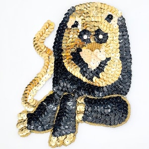 Lion with Black, Cream and Gold Sequins, Gold Beads and Rhinestone Eyes 5.5" x 4.75”
