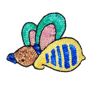 May include: A decorative patch shaped like a bee, crafted with vibrant sequins. The head is copper-colored, the wings feature teal and pink sequins, and the body displays alternating yellow and blue stripes, all outlined with black beads.