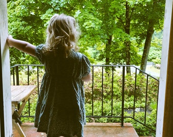 Girl on Porch in Rain