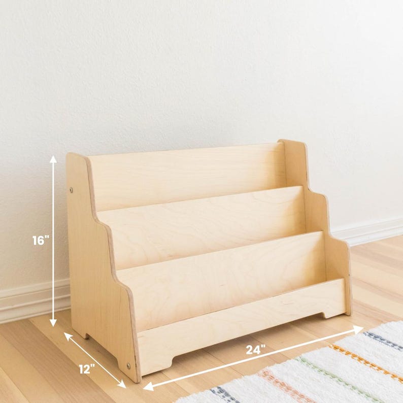 May include: A wooden bookshelf with three shelves, measuring 24 inches wide, 16 inches tall, and 12 inches deep. The bookshelf is made of natural wood and has a light brown finish.