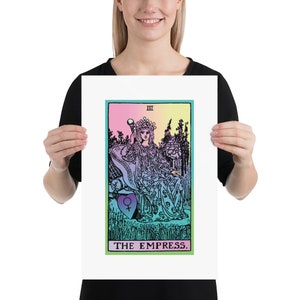 May include: A framed print of The Empress tarot card. The artwork features a seated woman with a crown, holding a scepter, set against a colorful background. The card is bordered in green, with the title "THE EMPRESS" at the bottom.