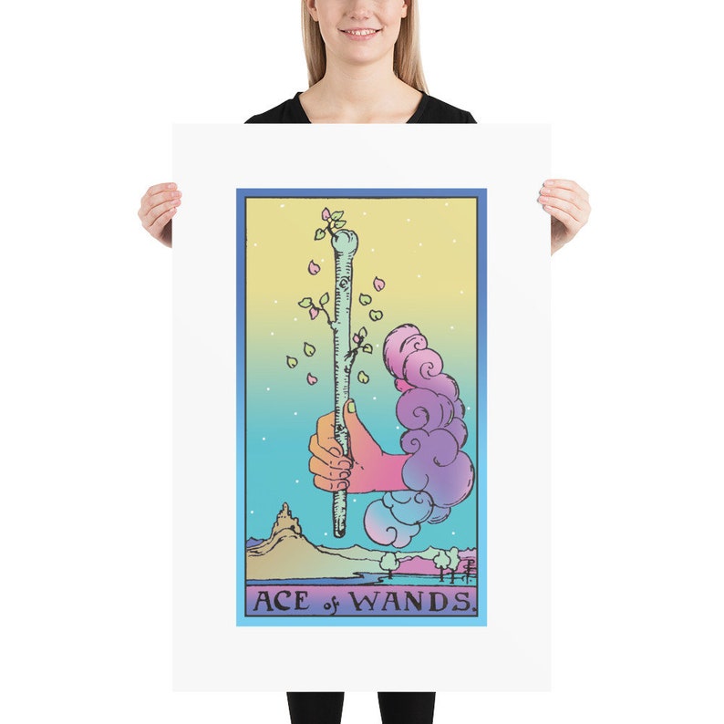 May include: A pastel-colored tarot card illustration of the Ace of Wands. The card features a hand holding a wand with a green sprout growing from the top. The background is a gradient of blue, pink, and yellow with clouds and a small mountain.