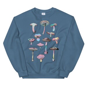 May include: A blue sweatshirt with a colorful mushroom graphic print. The mushrooms are in various shapes and sizes, with pink, blue, green, and yellow accents.
