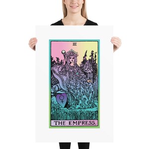 May include: A poster featuring a tarot card illustration of The Empress. The artwork is in a vintage style with a color palette of pastel pink, green, and yellow. The Empress is depicted seated, holding a scepter, with the card's title at the bottom.