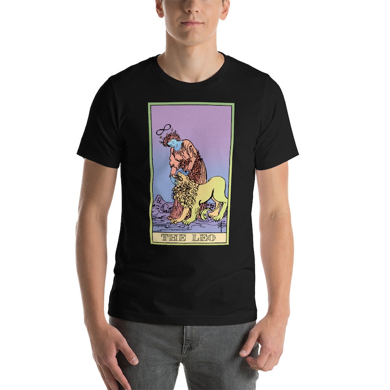 May include: Black t-shirt with a colorful illustration of the tarot card "The Leo". The card features a person with a halo and a lion.