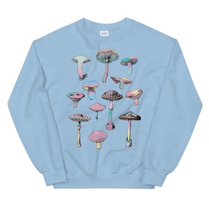 May include: Light blue sweatshirt with a colorful mushroom graphic print. The mushrooms are arranged in a random pattern on the front of the sweatshirt.