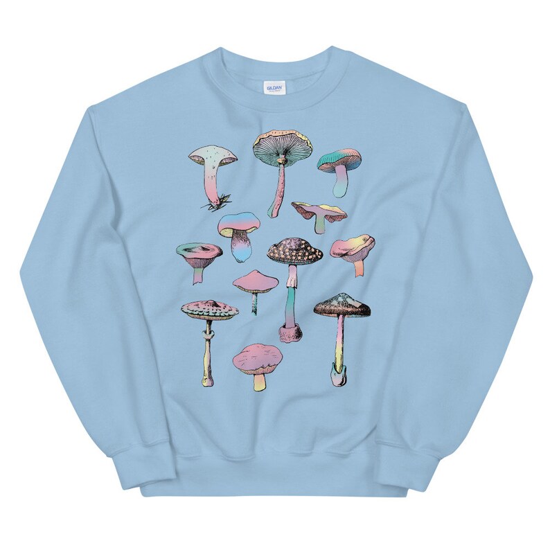 May include: Light blue sweatshirt with a colorful mushroom graphic print. The mushrooms are arranged in a random pattern on the front of the sweatshirt.
