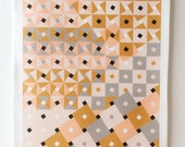 Dixon Tea Towel. Geometric print of pink, grey, and gold