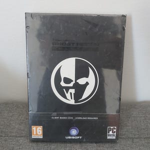 May include: A black video game box for "Tom Clancy's Ghost Recon: Breakpoint". It has a white skull logo and the Ubisoft logo. The game is rated 16 and requires a download. The box is sealed in plastic.