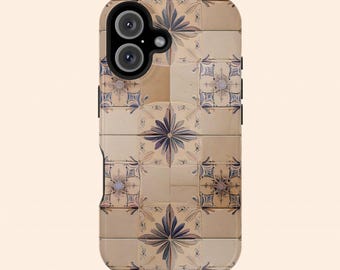 May include: A phone case with a design of beige and blue tiles with a floral pattern. The case has a black border and two camera lenses.