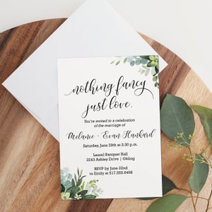 May include: Wedding invitation with a green leafy design. The text reads "nothing fancy just love."  You're invited to a celebration of the marriage of Melanie + Evan Hankard. Saturday, June 29th at 2:30 p.m. Laurel Banquet Hall 2243 Ashley Drive | Ohling RSVP by June 22nd to Emily at 517.555.6498