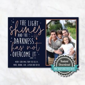 May include: A navy blue Christmas card with a family photo and text in rose gold. The text reads "The light shines and the darkness has not overcome it." The card also includes the family's names and the phrase "Instant Download."