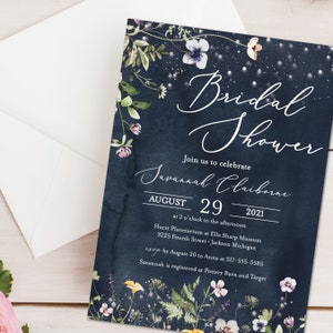May include: A navy blue bridal shower invitation with a floral design and the text "Bridal Shower", "Join us to celebrate", "Savannah Claiborne", "August 29, 2021", "at 2 o'clock in the afternoon", "Hurst Planetarium at Ella Sharp Museum", "3225 Fourth Street, Jackson Michigan", "RSVP by August 20 to Anna at 517-555-5585", and "Savannah is registered at Pottery Barn and Target".