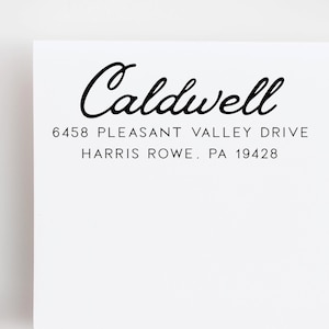 May include: White card with the name "Caldwell" in elegant black script. Below, the address reads "6458 Pleasant Valley Drive, Harris Rowe, PA 19428" in a simple, readable font. The design is clean and minimalist.