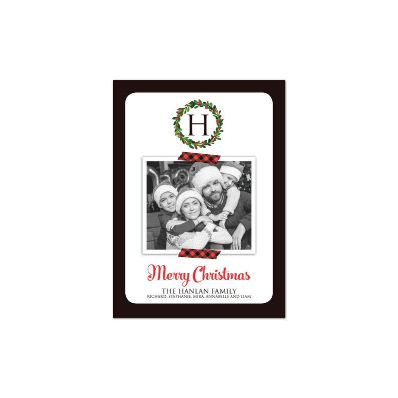 May include: A Christmas card with a black border and a white interior. The card features a family photo, a wreath with the letter "H", and the words "Merry Christmas". The family photo is secured with red and black plaid tape.