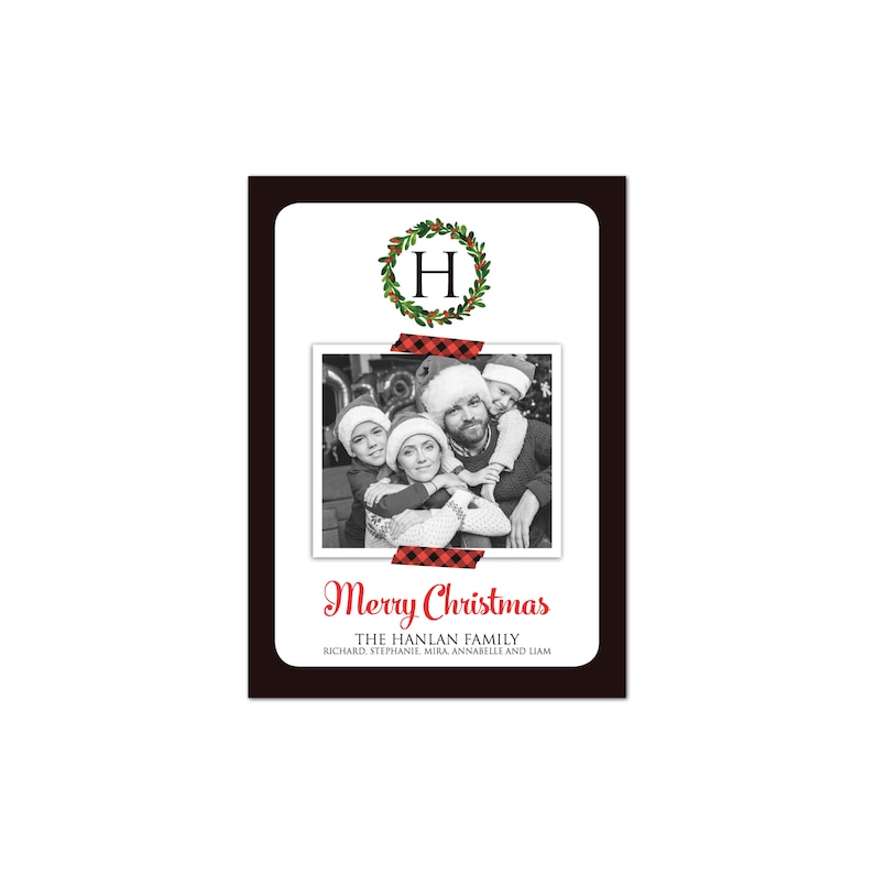 May include: A Christmas card with a black border and a white interior. The card features a family photo, a wreath with the letter "H", and the words "Merry Christmas". The family photo is secured with red and black plaid tape.