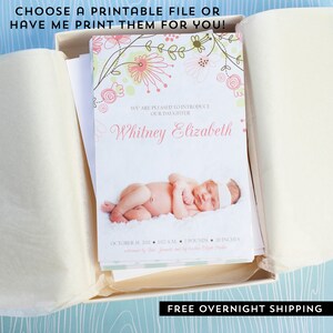 May include: A newborn announcement card featuring a baby photo, floral design, and the name "Whitney Elizabeth." The card includes details like birth date, time, weight (7 pounds), and length (20 inches). The text reads "Choose a printable file or have me print them for you!"