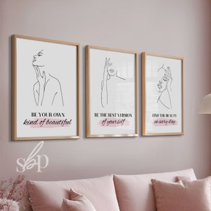 May include: Three framed prints with black line drawings of women's faces and inspirational quotes. The first print says "Be your own kind of beautiful." The second print says "Be the best version of yourself." The third print says "Find the beauty in every day."