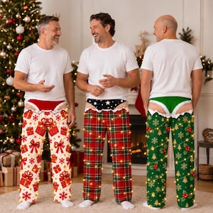 May include: Three pairs of holiday-themed pajama pants worn with white t-shirts. The first pair is white with red gift boxes, the second is red and green plaid, and the third is green with gold trees and snowflakes, all featuring faux underwear.