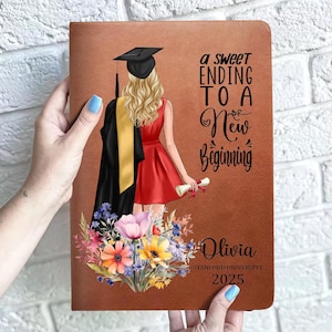 May include: Brown graduation journal with a drawing of a graduate in a red dress, holding a diploma. The journal cover has the text "a sweet ending to a new beginning", the name "Olivia", and "Stanford University 2025".