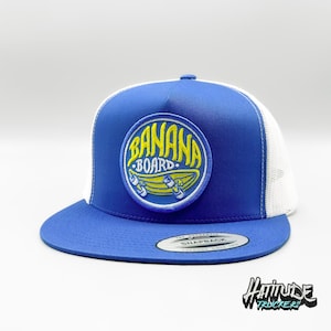 May include: A blue and white trucker hat with a yellow and blue embroidered patch that says "Banana Board".