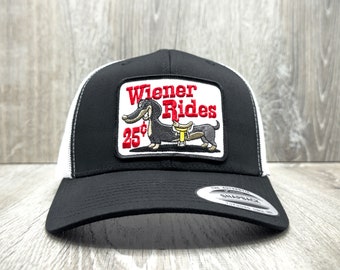 Wiener Rides 25 Cents Funny Trucker Hat on a Yupoong 6606 curved mid-crown