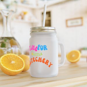 May include: White mason jar mug with a handle, featuring the text "Time for a little butchery" in rainbow colors. The mug has a silver lid and a white straw.