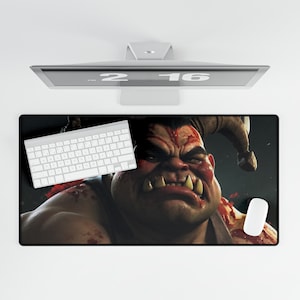 May include: A black and red gaming mouse pad featuring a close-up of a monstrous creature with sharp teeth and a bloody face.