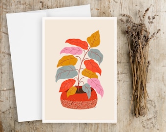 May include: A colorful illustration of a potted plant with red, orange, yellow, blue, and pink leaves. The plant is in a red pot with white speckles.