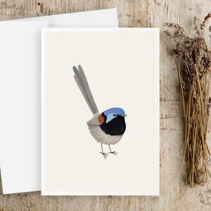 May include: A white card with a hand-painted illustration of a blue-capped, black-bodied bird with a long tail. The bird is standing on a white background.