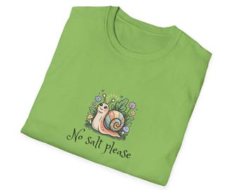 May include: Lime green t-shirt featuring a cartoon snail with a colorful shell, surrounded by flowers and mushrooms. The text "No salt please" is written below the snail in a whimsical font. The shirt is folded.