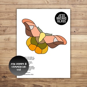 May include: A stained glass pattern of a butterfly with orange, brown, yellow, and green colors. The pattern is for hobby or commercial use. The text "JESS BREAKS GLASS" is in a circle at the top of the page.