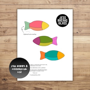 Puede incluir: Un papel blanco con tres diseños de peces coloridos. Cada pez está segmentado con diferentes colores: rosa, amarillo, verde, morado, turquesa y naranja. El texto "JESS BREAKS GLASS" está en un círculo negro. Texto en la parte inferior: "FOR HOBBY & COMMERCIAL USE."