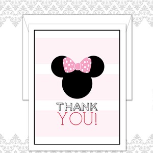 May include: A pink and white striped card with a black silhouette of a mouse head and a pink polka dot bow. The words "THANK YOU!" are printed in black and red.