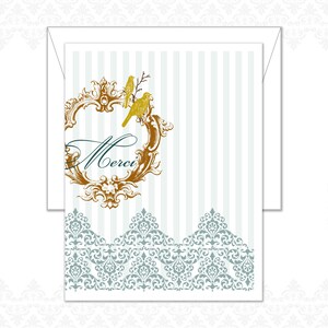May include: A white card with a gold and teal design. The card features a gold ornate frame with two gold birds and the word "Merci" in teal script. The background has vertical stripes and a teal and white patterned border.