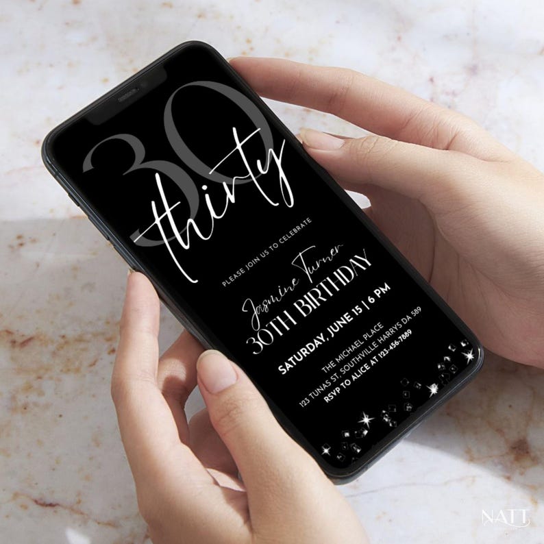 A close-up photo of hands holding a phone with the black 30th birthday invitation displayed on screen, realistic view.