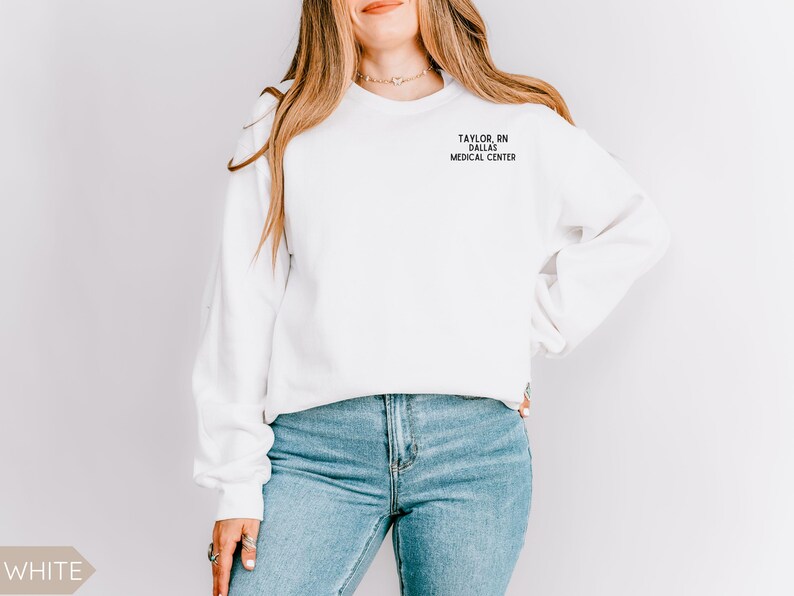 May include: White sweatshirt with the text "TAYLOR, RN DALLAS MEDICAL CENTER" printed on the front.