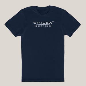 May include: A navy blue t-shirt with the SpaceX logo and the text "Occupy Mars" in white.