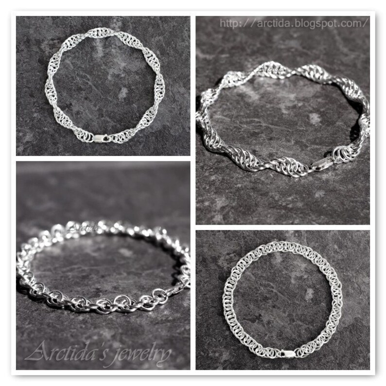 May include: Four silver chain necklaces with different styles and designs. The necklaces are displayed on a gray textured background. The text "Arctida's jewelry" is visible in the bottom left corner.