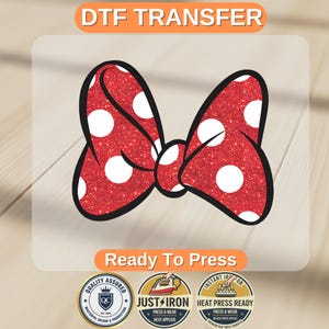 May include: A red glitter bow with white polka dots, outlined in black. The text "DTF TRANSFER" is at the top, and "Ready To Press" is at the bottom. Below are three circular logos with text.