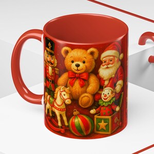 May include: Red ceramic mug featuring a festive Christmas design. The mug showcases illustrations of a teddy bear, Santa Claus, a toy soldier, a rocking horse, a clown in a box, and a Christmas ornament. The mug has a red handle and interior.