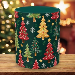 May include: A green ceramic mug with a Christmas tree pattern. The trees are decorated with red, green, yellow, and white accents.