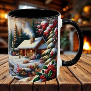 May include: A white ceramic mug with a black rim and handle features a winter scene with a cozy cabin in a snowy forest. The cabin has a red door and windows, and the forest is decorated with red berries.