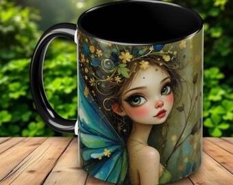 May include: Black ceramic mug with a colorful illustration of a fairy with blue wings and a floral crown. The fairy has green eyes and pink cheeks.